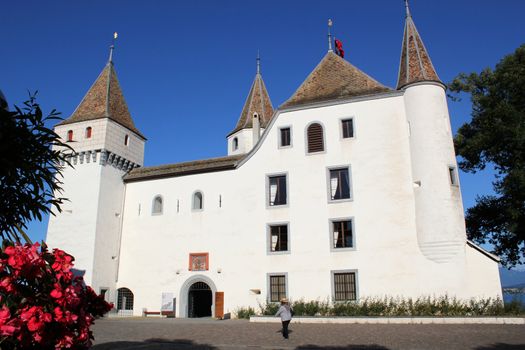 Facade and entrance of the white old castle in Nyon, Switzerland