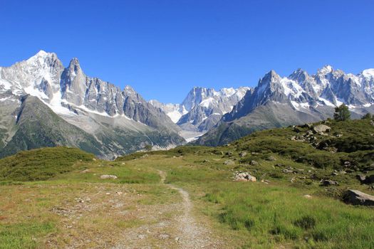 View of the Mont-Blanc massif from a small path in the mountain, France, by beautiful weather