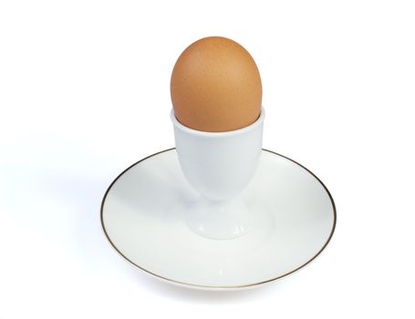 The egg in eggcup is on the white background