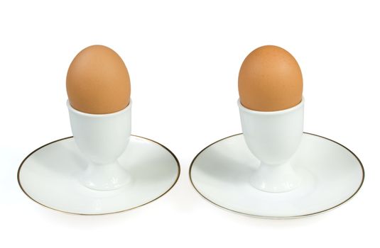 The egg in eggcup is on the white background