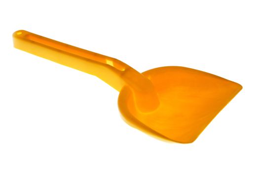 Orange toy shovel isolated on a white background.