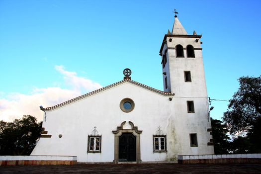 Full frontal view of a small Christian church on the village of Barranco do Velho in Algarve, Portugal.