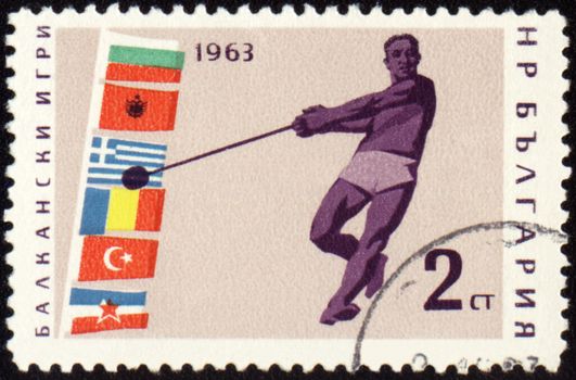 BULGARIA - CIRCA 1963: A post stamp printed in Bulgaria shows sportsman with hammer, devoted to Balkan games, series, circa 1963