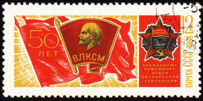 USSR - CIRCA 1968: A stamp printed in USSR, shows banner of komsomol with badge and Order of October Revolution, devoted to the 50-th anniversary of komsomol, circa 1968