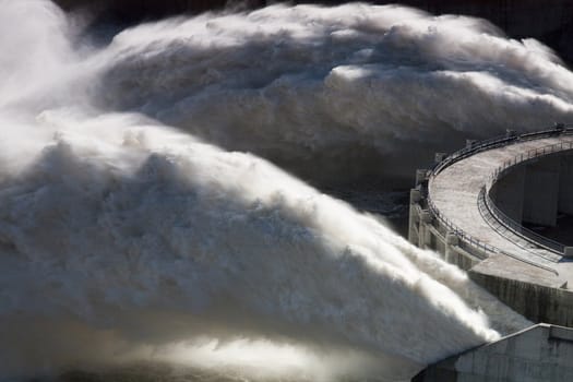View of two powerful jets of water on the Alqueva dam, Portugal.