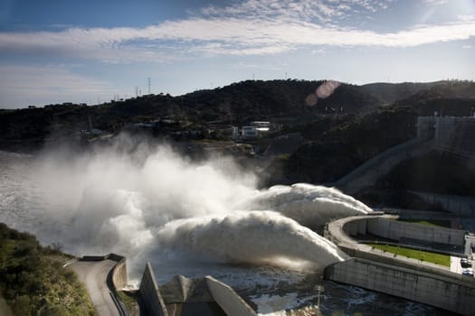 View of two powerful jets of water on the Alqueva dam, Portugal.