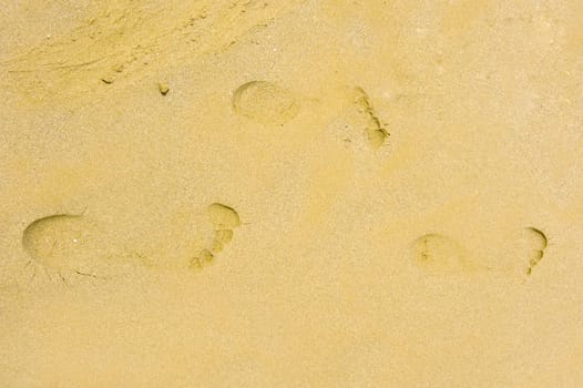 three footsteps in the sand