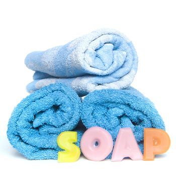 a blue towel and soapletters spelling "soap"
