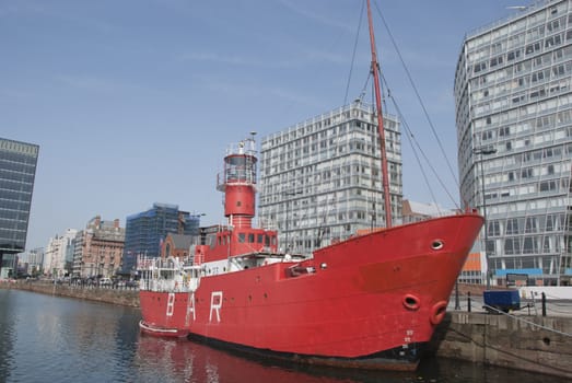 A Red Lighthouse Ship in an English City Dock