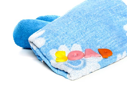 a blue towel and soapletters spelling "soap"