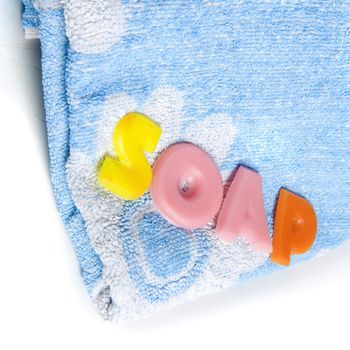 a blue towel and soapletters spelling "soap"
