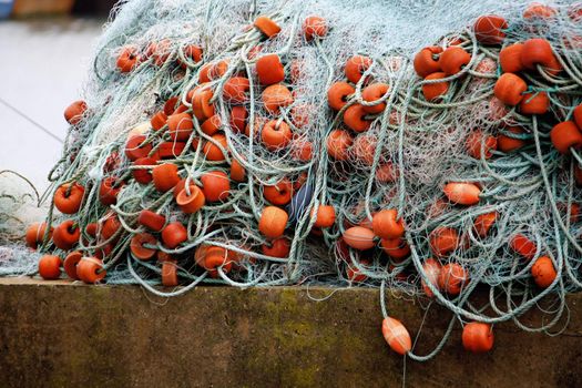 View of many plastic floaters on a fishing net on a harbor.