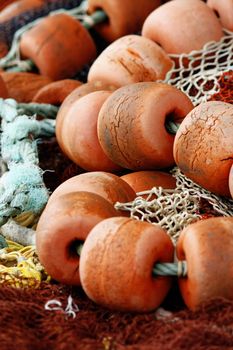 Close view of some fishing net floaters on the docks.