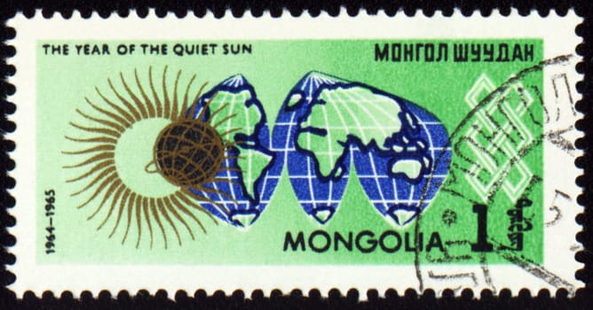 MONGOLIA - CIRCA 1965: stamp printed in Mongolia, shows map Globe and symbol of the Sun, series "The year of quiet Sun", circa 1965