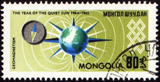 MONGOLIA - CIRCA 1965: stamp printed in Mongolia, shows geomagnetic field and compass, series "The year of quiet Sun", circa 1965