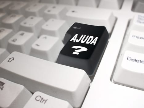 black enter key on a white keyboard with the following phrase: "Ajuda ?"