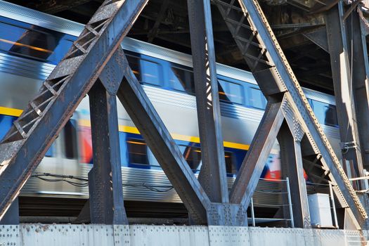 Passing train on an old rusty train bridge