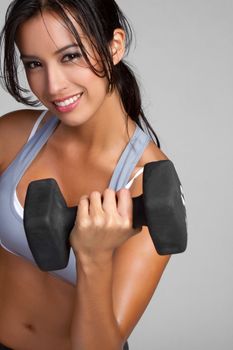 Smiling fitness woman lifting weights