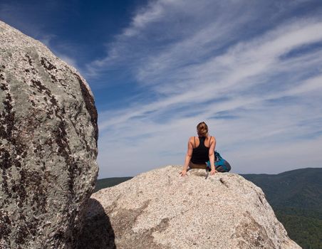 Female hiker looks over valley in the Shenandoah on a climb of Old Rag