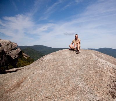 Senior hiker looks over valley in the Shenandoah on a climb of Old Rag