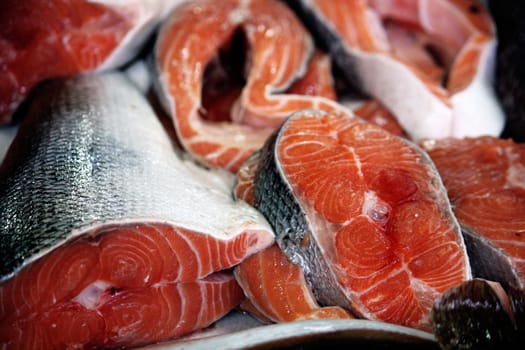 View of several fresh sliced salmon fish at the market.  