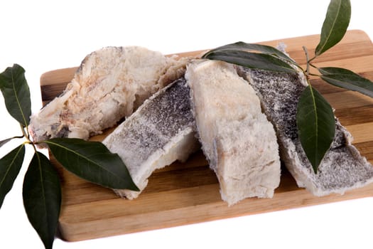 View of a bunch of sliced salted codfish isolated on a white background.