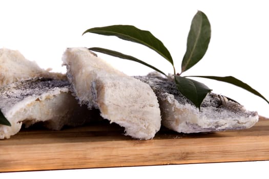 View of a bunch of sliced salted codfish isolated on a white background.