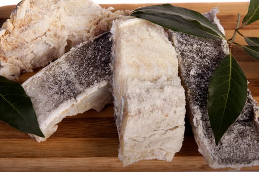 View of a bunch of sliced salted codfish isolated on a white background.