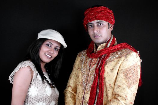 A young Indian man and woman wearing clothes of diverse fashion.