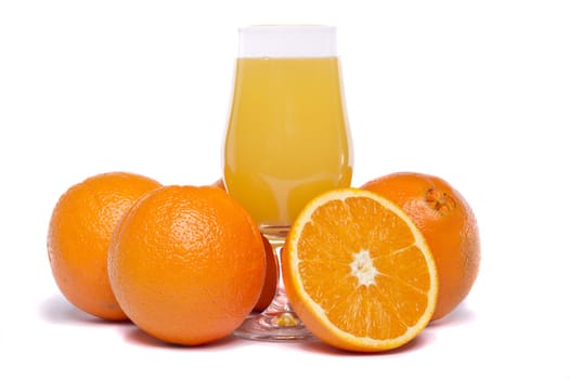 Close view of a bunch of oranges with glass of juice isolated on a white background