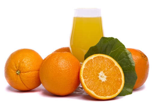 Close view of a bunch of oranges with glass of juice, isolated on a white background