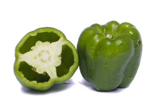 Close view of a green bell pepper isolated on a white background.