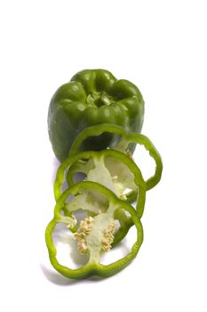 Close view of a green bell pepper isolated on a white background.