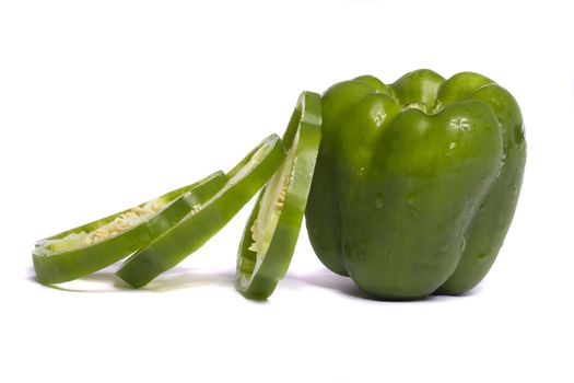 Close view of a green bell pepper isolated on a white background.