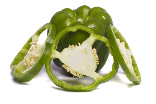 Close view of a green bell pepper isolated on a white background.