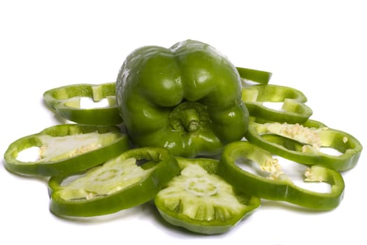 Close view of a green bell pepper isolated on a white background.