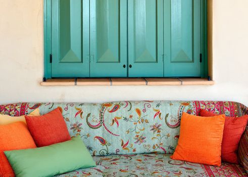 A colorful traditional sofa in the porch of a Greek island house