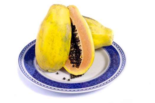Close up view of papaya fruit sliced presented on a dish. 