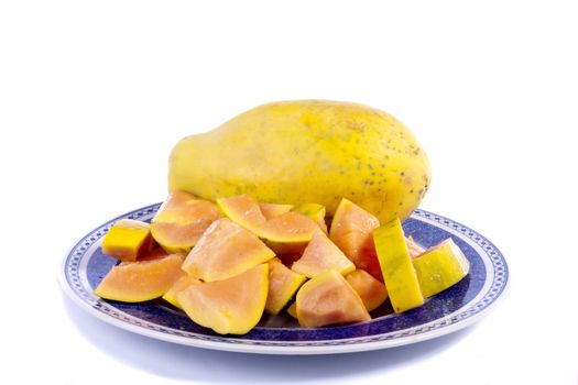 Close up view of papaya fruit sliced presented on a dish. 