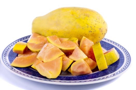 Close up view of papaya fruit sliced presented on a dish. 