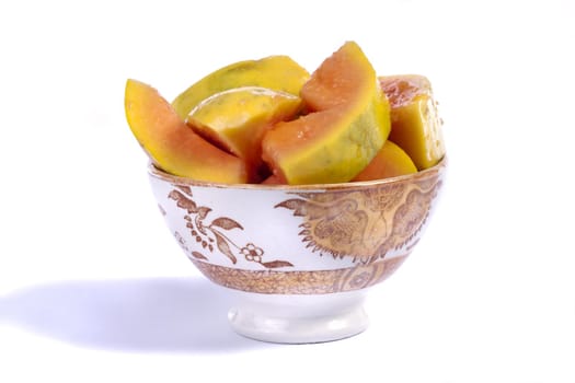 Close up view of papaya fruit sliced presented on a bowl. 