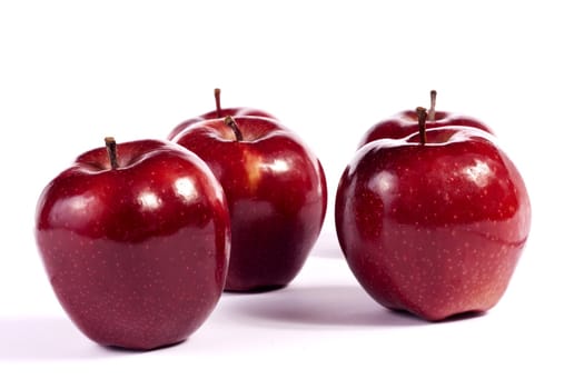 Close up view of some red apples isolated on a white background.