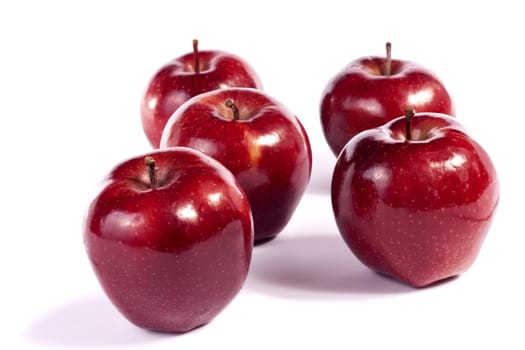 Close up view of some red apples isolated on a white background.