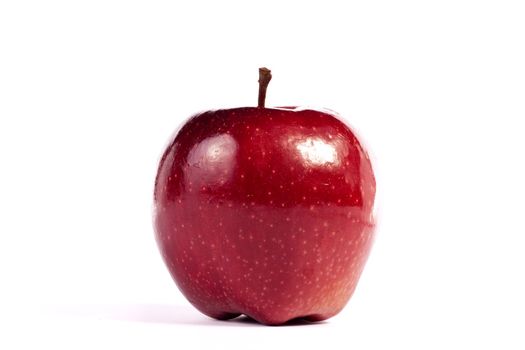 Close up view of a single red apple isolated on a white background.