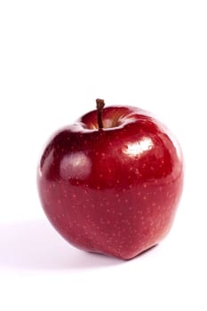 Close up view of a single red apple isolated on a white background.