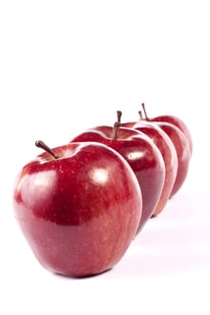 Close up view of some red apples isolated on a white background.