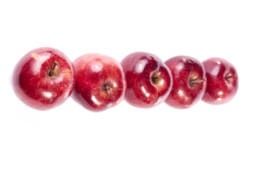Close up view of some red apples isolated on a white background.