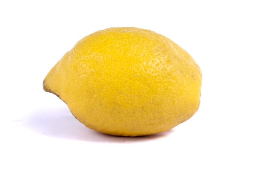 Close up view of a single lemon isolated on a white background.