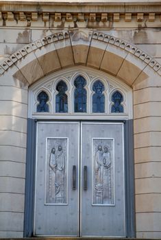 Engraves metal chruch doors with concrete steps