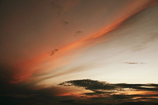 Streak of colored cloud in a pre-dawn sky